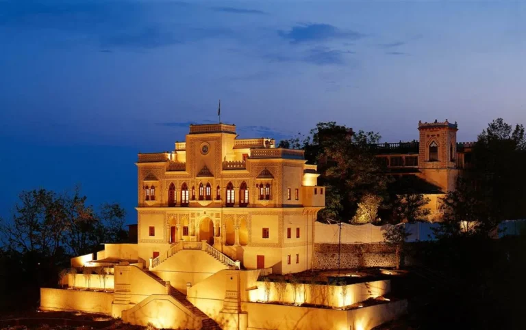 Illuminated view of Ananda in the Himalayas luxury wellness retreat overlooking the Ganges valley at dusk